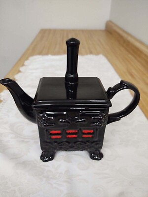 #ad Vtg. ceramic cast iron stove teapot; black glaze orange. $40.00