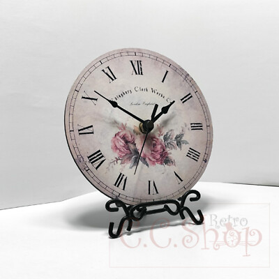 #ad Table clock with a round dial on a metal stand Table clock with quartz movement $24.99